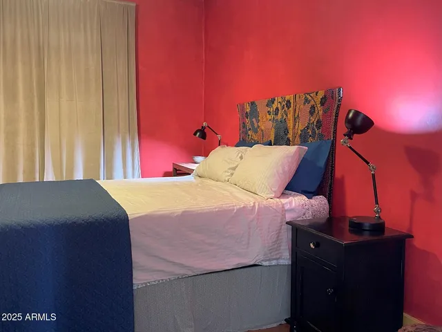 a bed sitting in a bedroom next to a window