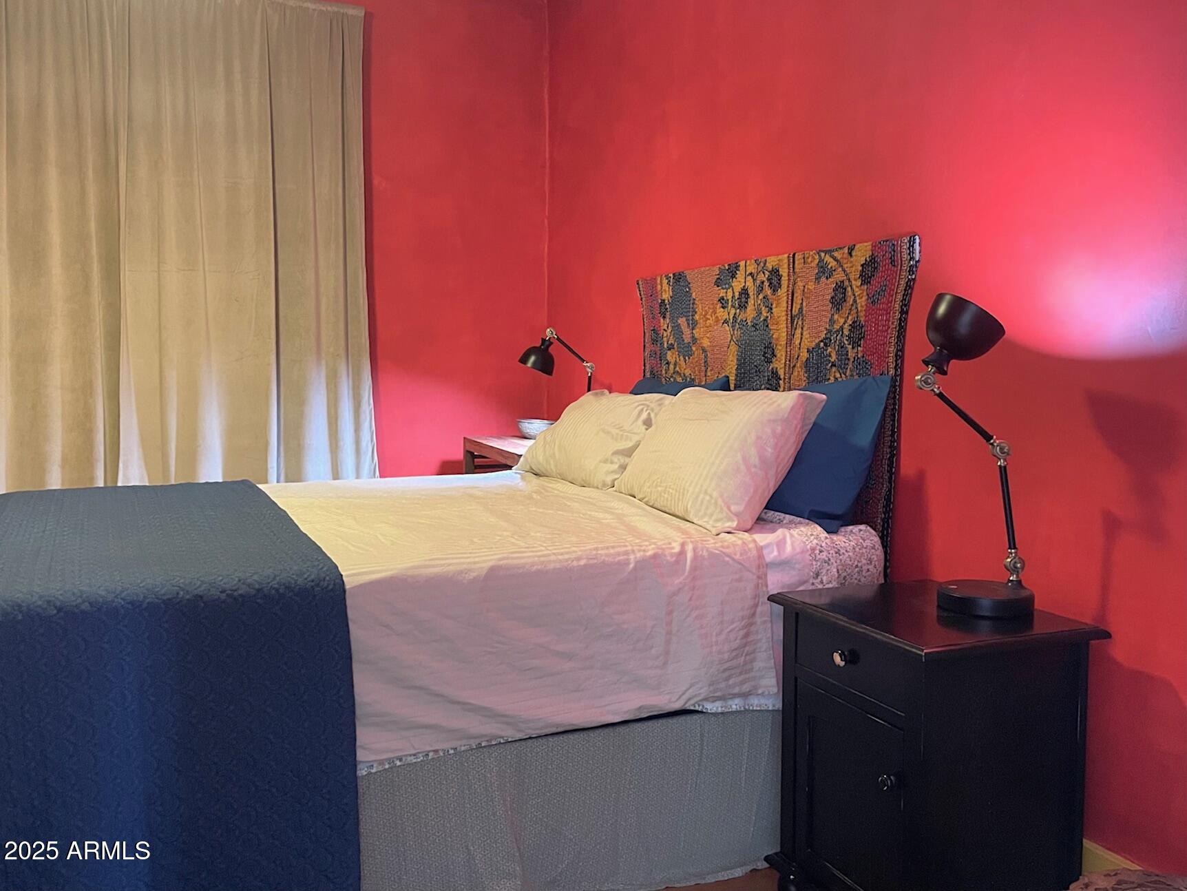 5 Old Douglas Road Bisbee, AZ 85603 - Photo 32 of 35 a bed sitting in a bedroom next to a window