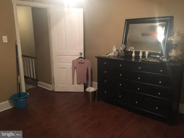 an entryway door with wooden floor