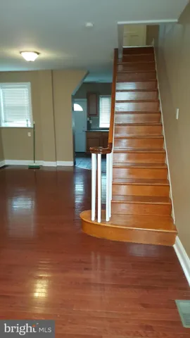 a view of a living room with hardwood floor