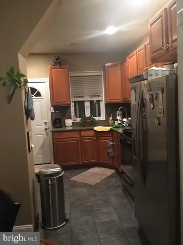 a kitchen with refrigerator cabinets and window