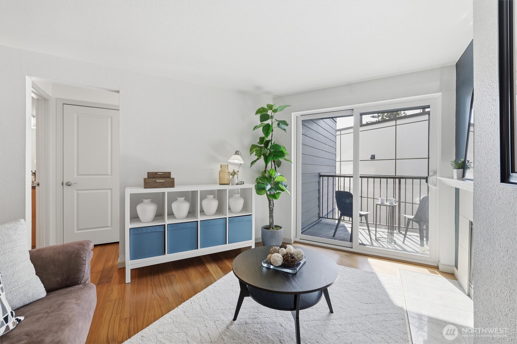 3045 20th Avenue West, Unit 303 Seattle, WA 98199 - Photo 14 of 28 a living room with furniture and a wooden floor