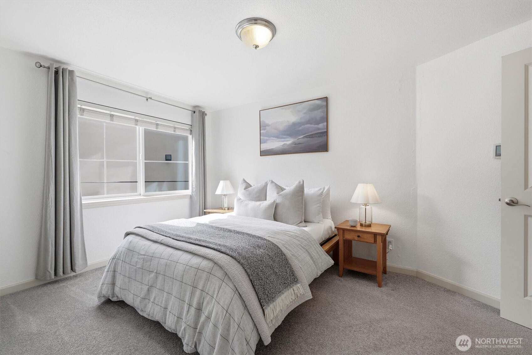 3045 20th Avenue West, Unit 303 Seattle, WA 98199 - Photo 17 of 28 a bedroom with bed and a window