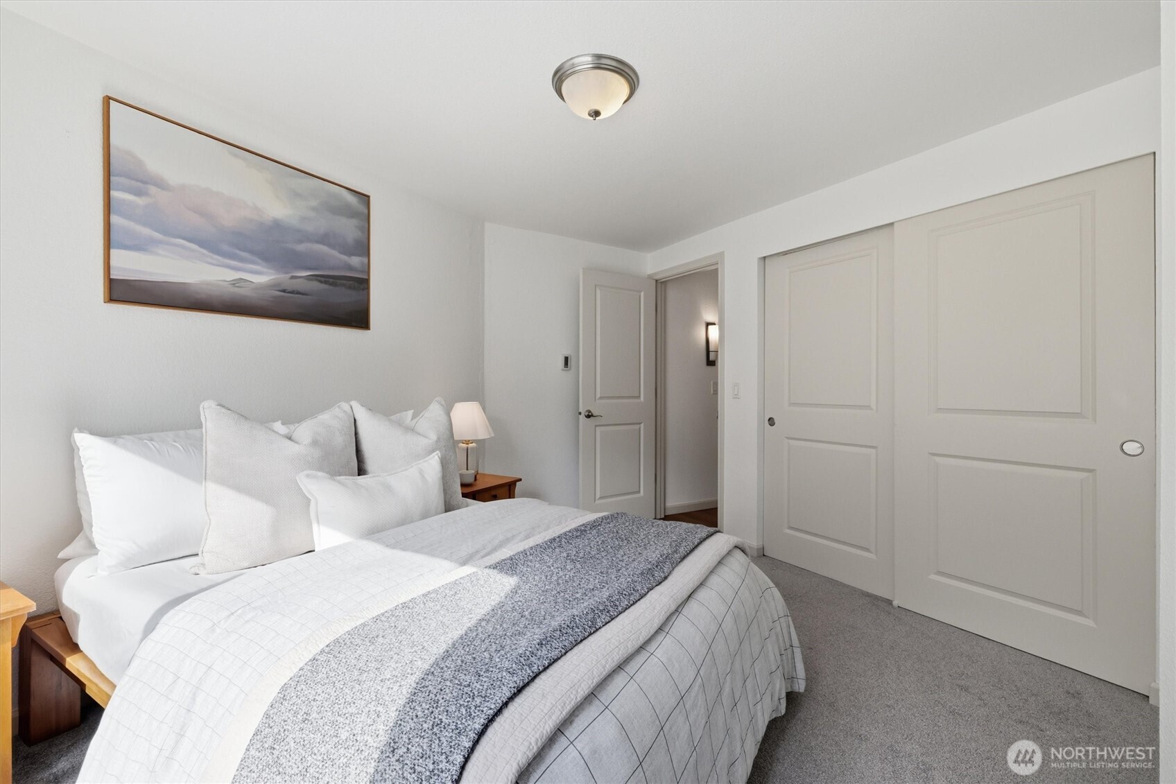 3045 20th Avenue West, Unit 303 Seattle, WA 98199 - Photo 19 of 28 a bedroom with bed and wall painting