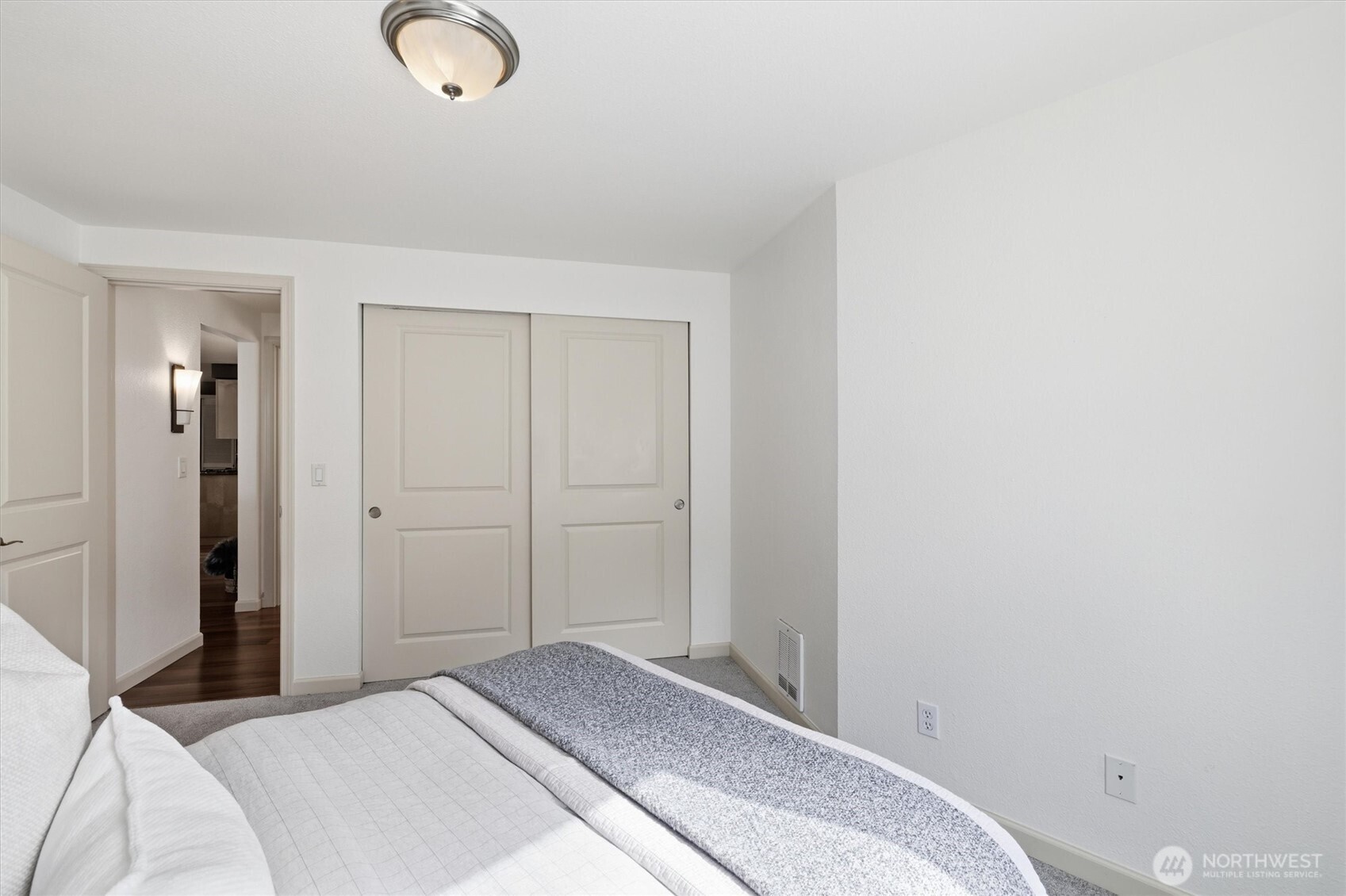 3045 20th Avenue West, Unit 303 Seattle, WA 98199 - Photo 20 of 28 a bedroom with a bed and cabinets