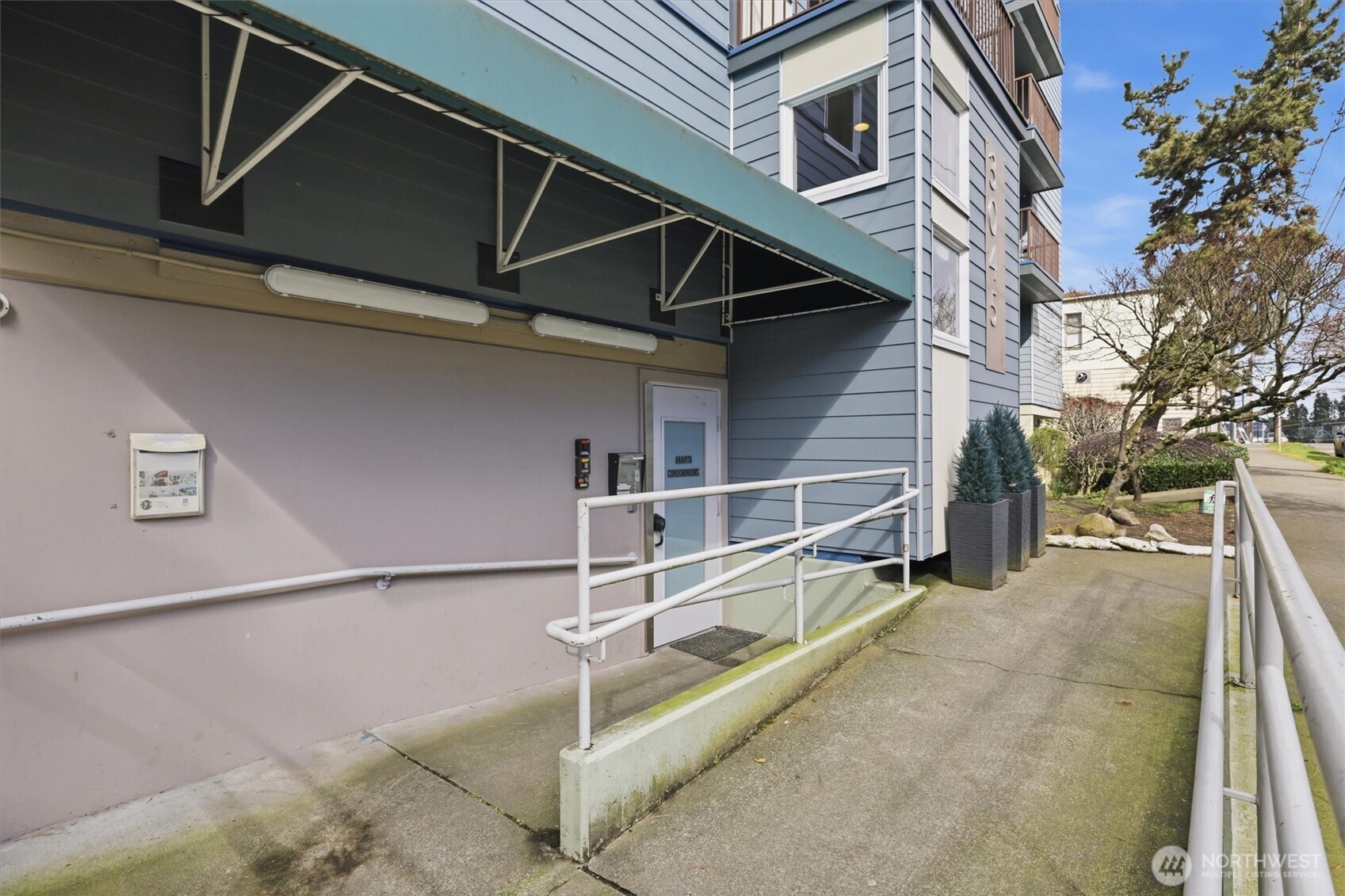3045 20th Avenue West, Unit 303 Seattle, WA 98199 - Photo 4 of 28 a view of a house with a street