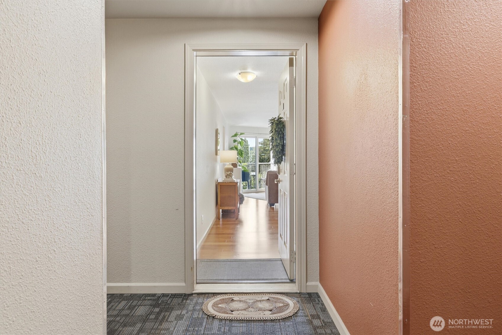 3045 20th Avenue West, Unit 303 Seattle, WA 98199 - Photo 6 of 28 a view of a hallway with wooden floor and a livingroom