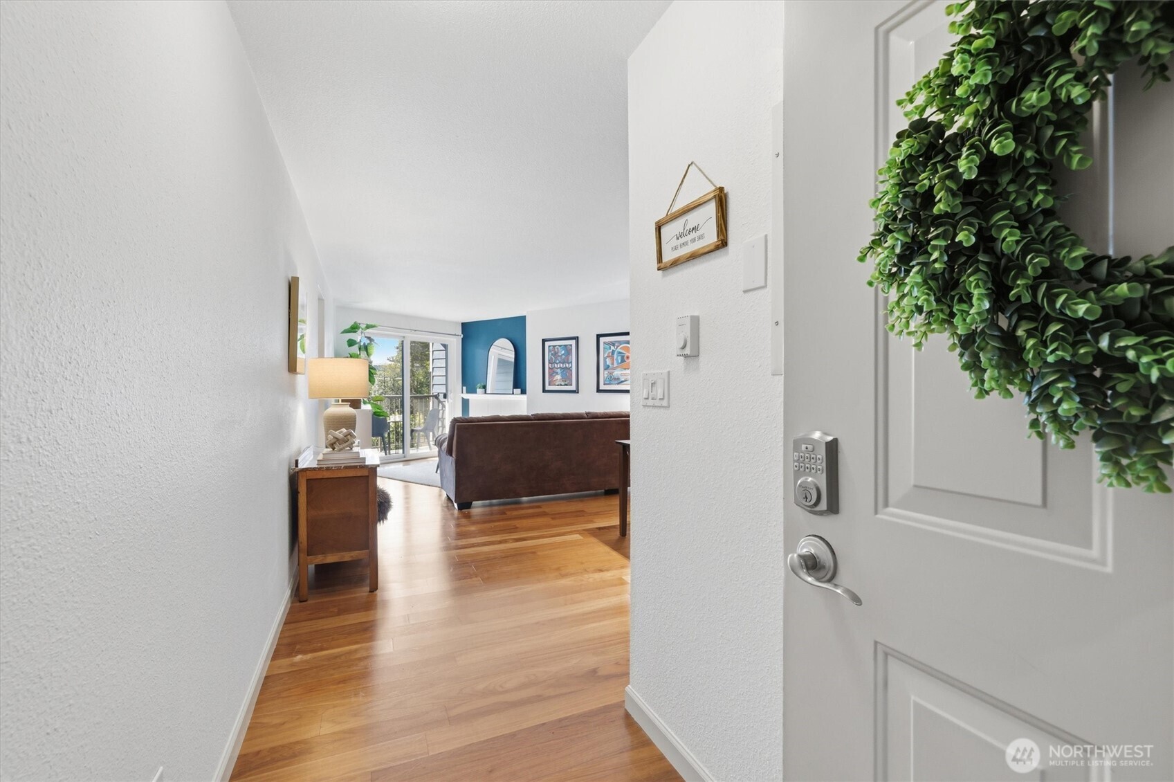 3045 20th Avenue West, Unit 303 Seattle, WA 98199 - Photo 7 of 28 a living room with furniture and a potted plant