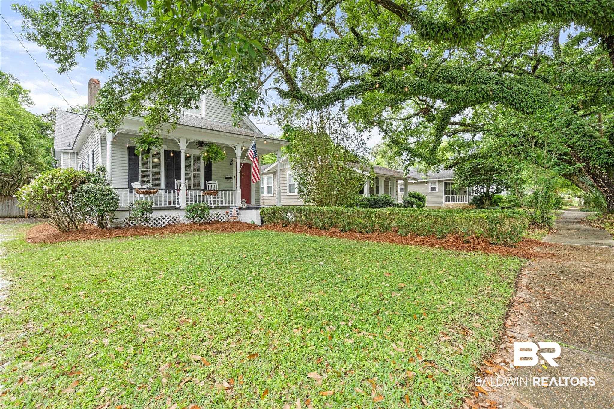 20 Hurlbert Street Mobile, AL 36607 - Photo 30 of 33 View of front of house featuring a porch, a front lawn, and a chimney