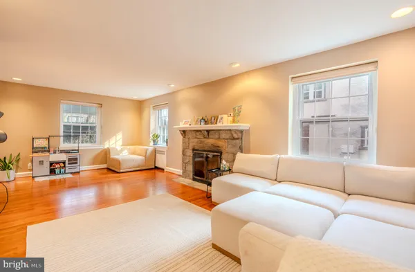 a living room with furniture large window and a fireplace