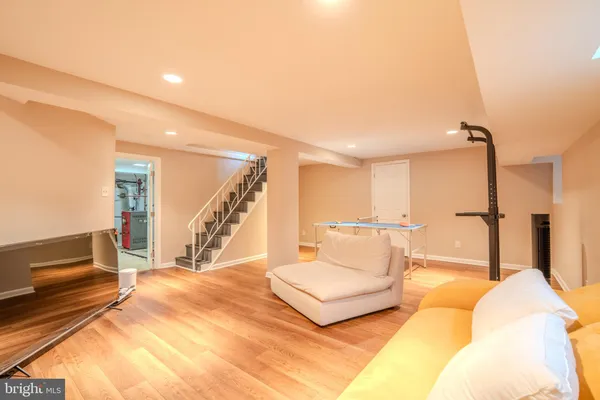 a spacious bedroom with a bed a couch and a view of living room