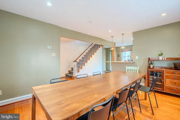 a dining room with furniture and wooden floor