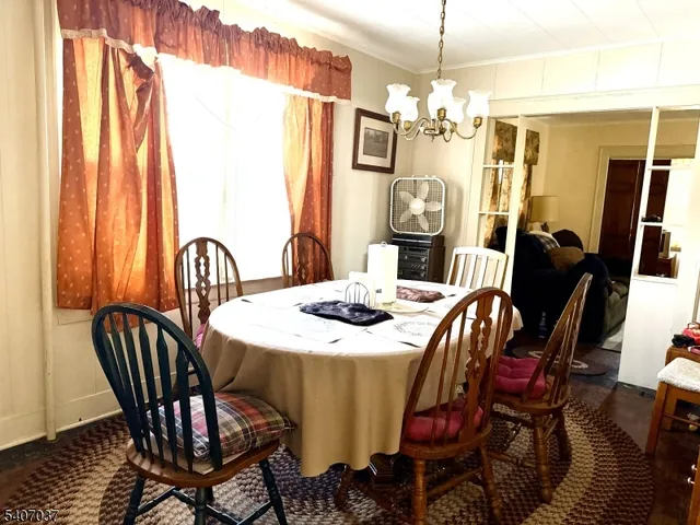 a view of a dining room with furniture and window