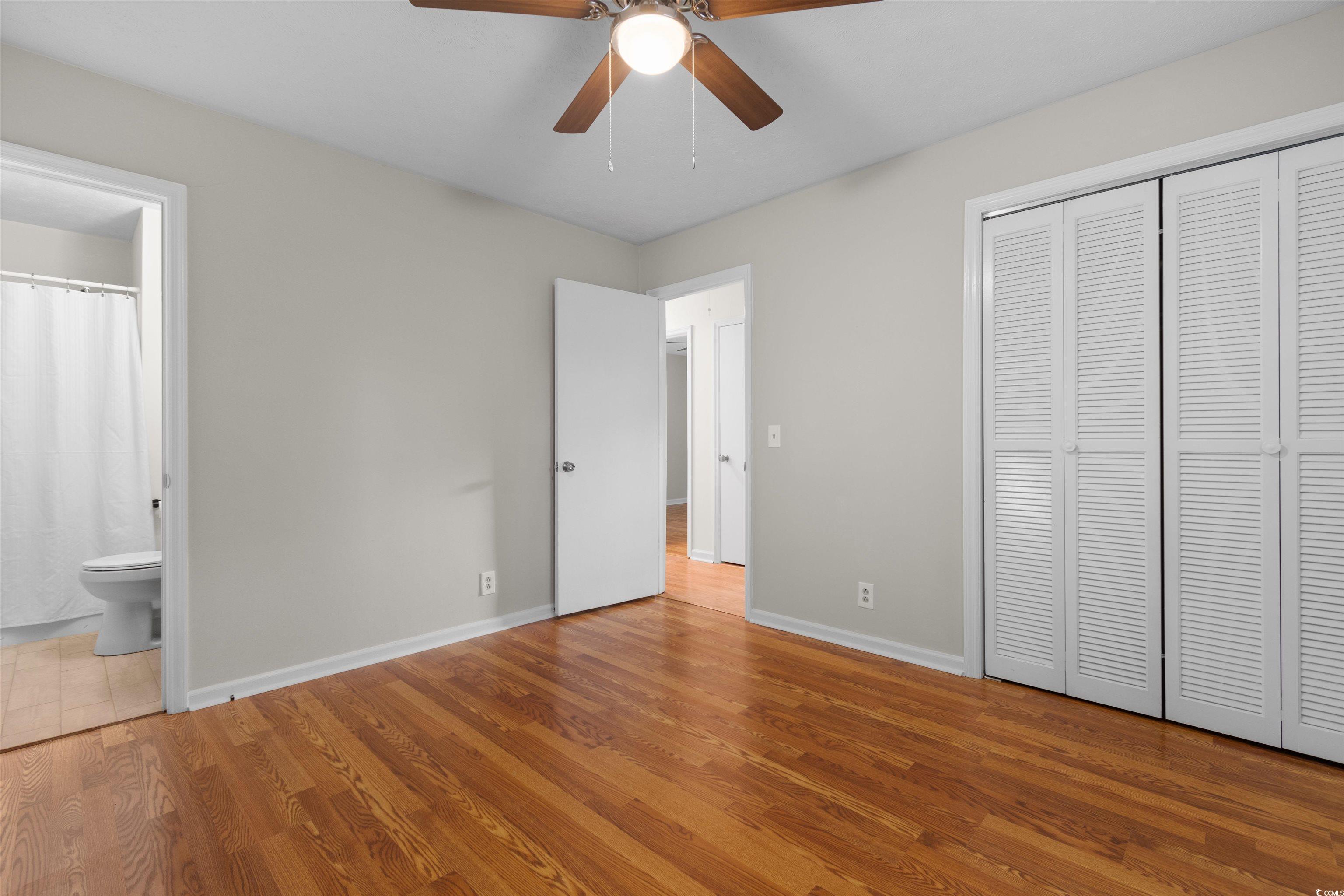 3870 Woodchuck Road Myrtle Beach, SC 29579 - Photo 11 of 32 Unfurnished bedroom featuring a closet, hardwood /