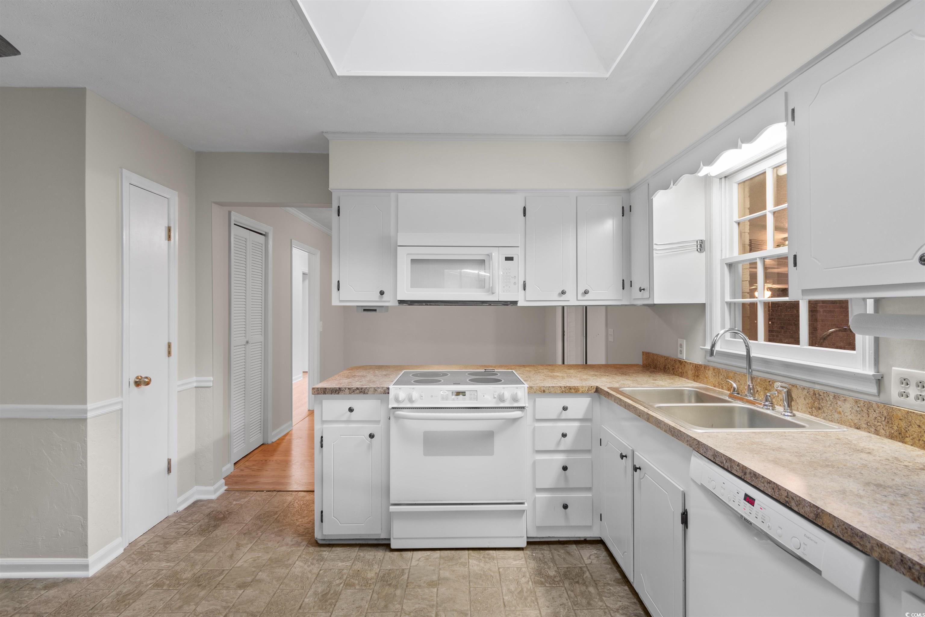 3870 Woodchuck Road Myrtle Beach, SC 29579 - Photo 8 of 32 Kitchen with white cabinets, white appliances, sin