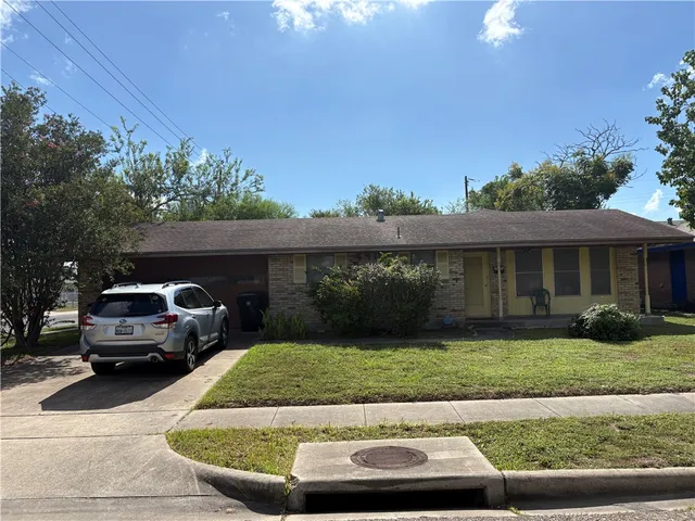 a view of a car parked in front of a house