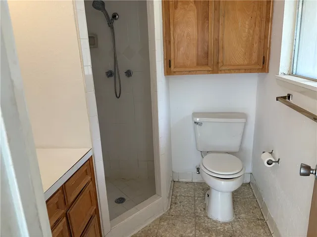 a bathroom with a toilet and a shower