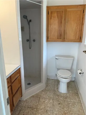 a bathroom with a toilet and a shower