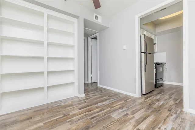 a view of wooden floor and closet in a room