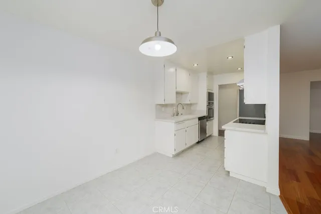 a kitchen with stove cabinets and white appliances