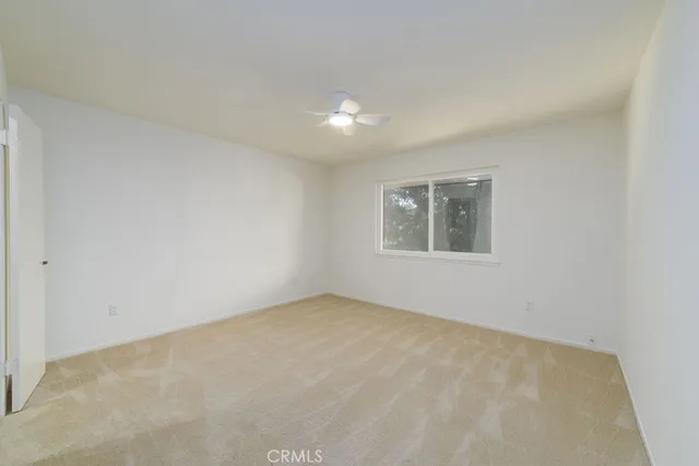 a bedroom with a bed couch and a window