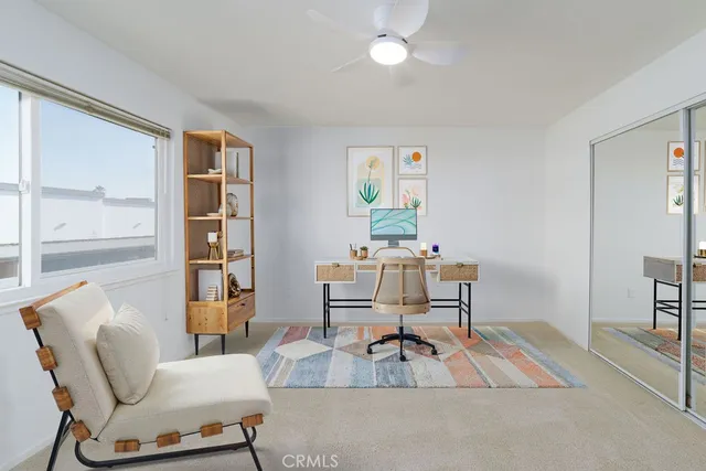 a living room with furniture a dining table and a large window