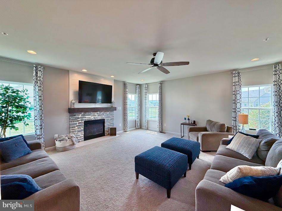 3012 Wasatch View Drive Frederick, MD 21704 - Photo 11 of 54 a living room with furniture a fireplace and a flat screen tv
