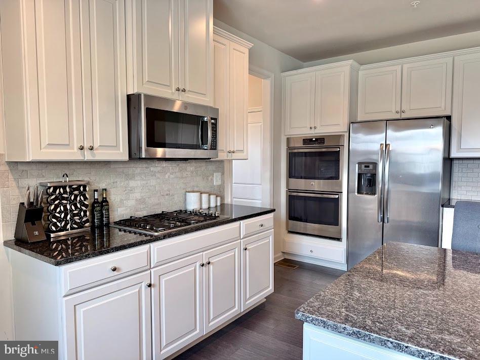 3012 Wasatch View Drive Frederick, MD 21704 - Photo 19 of 54 a kitchen with granite countertop a refrigerator sink and microwave