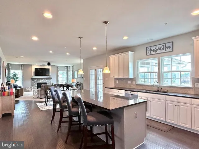 a living room with furniture a flat screen tv and a window