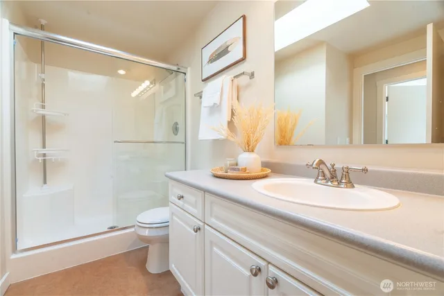 a bathroom with a sink a toilet and shower