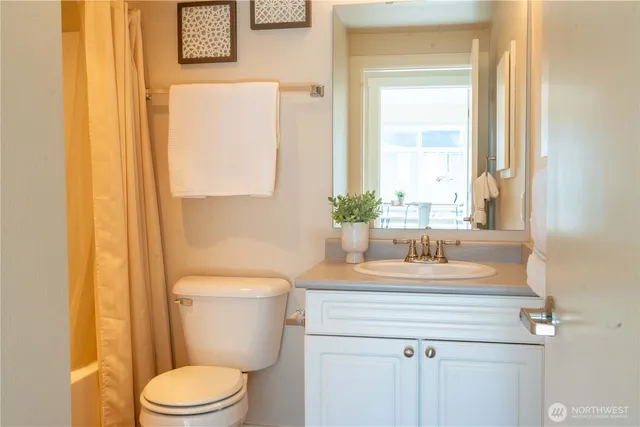 a bathroom with a sink a toilet and a mirror