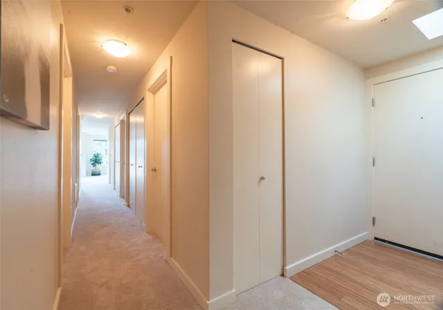 a view of a hallway with wooden floor