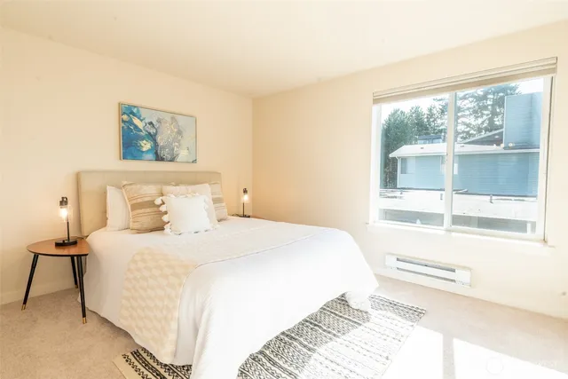 a bedroom with a bed and a large window