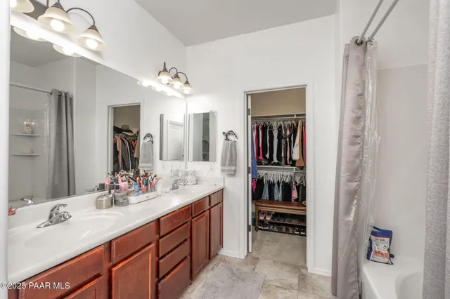 a bathroom with a sink double vanity and a mirror