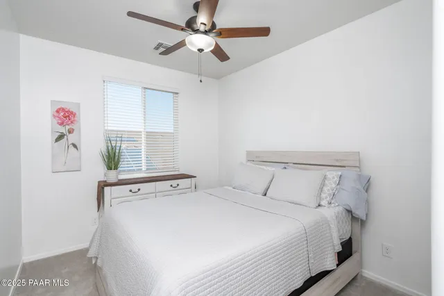 a bedroom with a large bed and a window