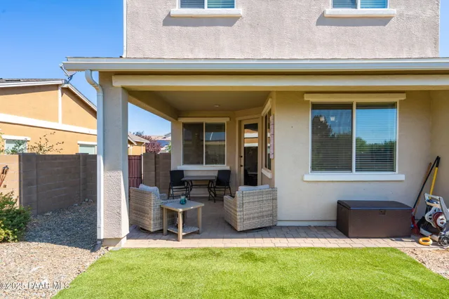 a view of a patio with a table and chairs and potted plants