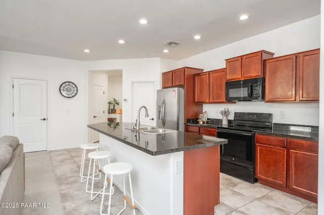 a kitchen with stainless steel appliances granite countertop a sink and cabinets