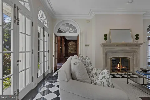 a view of a livingroom with furniture chandelier and wooden floor