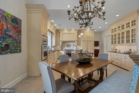 a view of an empty room with wooden floor and furniture