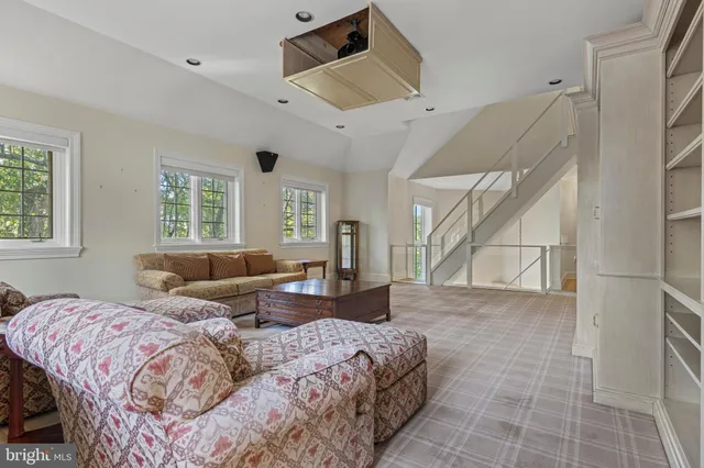 a living room with furniture and a chandelier