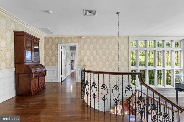 a view of a hallway a livingroom with furniture and windows