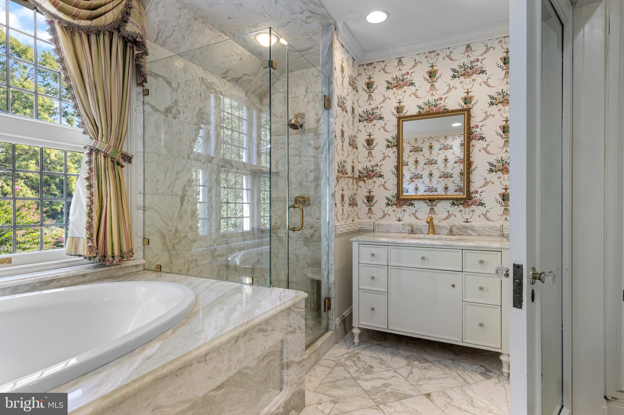 717 North Spring Mill Road Villanova, PA 19085 - Photo 41 of 62 a spacious bathroom with a granite countertop sink mirror and a bathtub