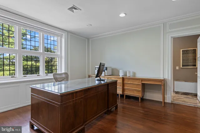 an aerial view of a house with swimming pool and garden space