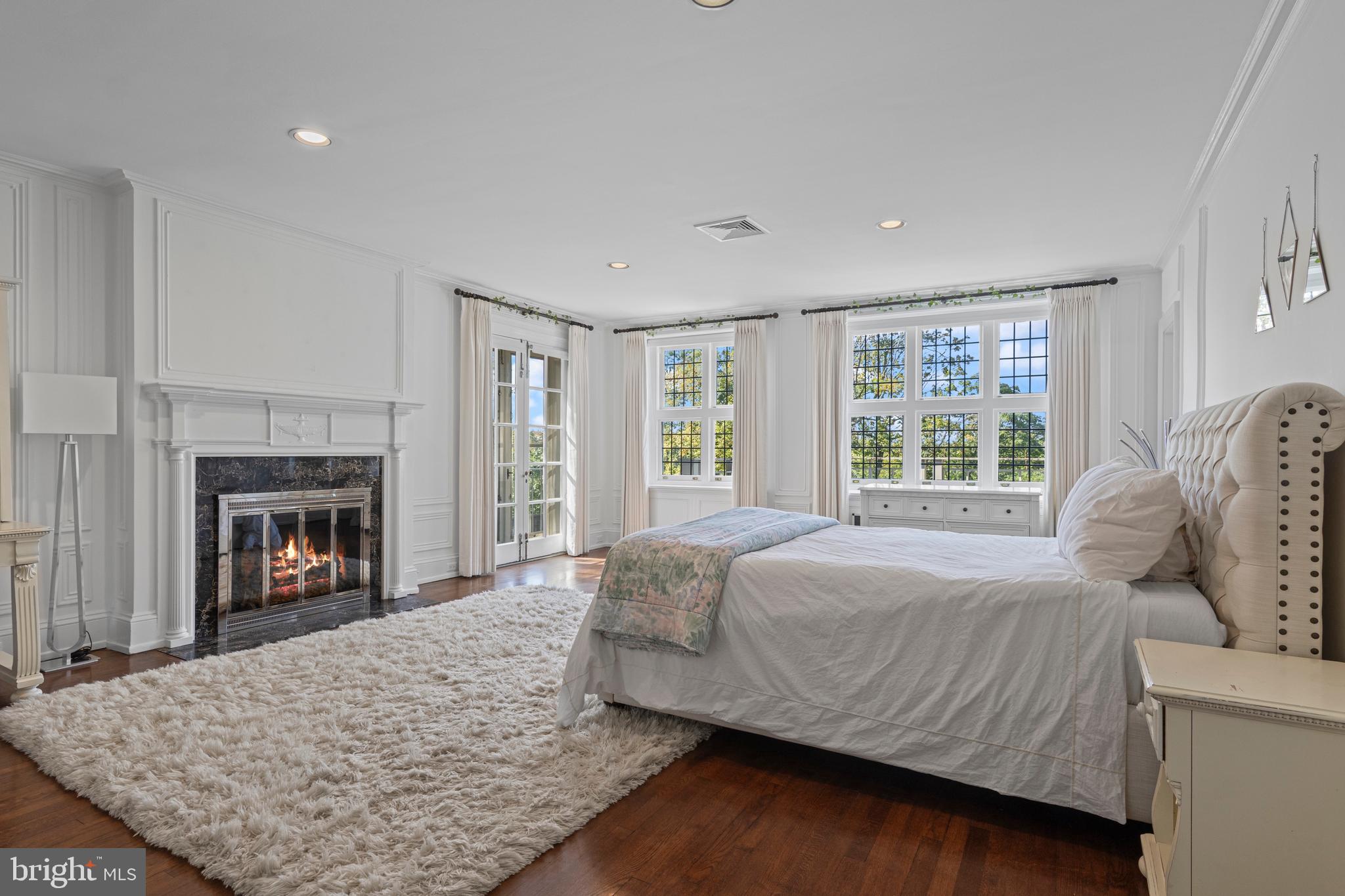 717 North Spring Mill Road Villanova, PA 19085 - Photo 45 of 62 a bed sitting in a bedroom next to a fireplace and window
