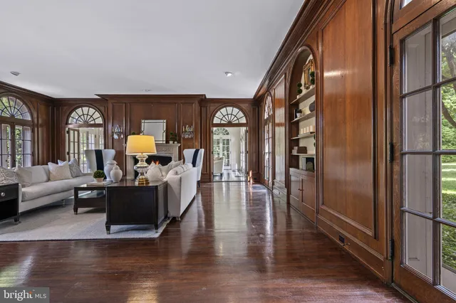 a living room with furniture a fireplace and a large window