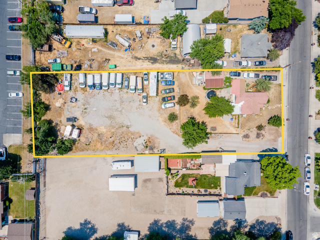 72 Cox Lane Midvale, UT 84047 - Photo 5 of 16 Expansive lot featuring a single-story residence with a red tile roof, complemented by mature trees and significant open land