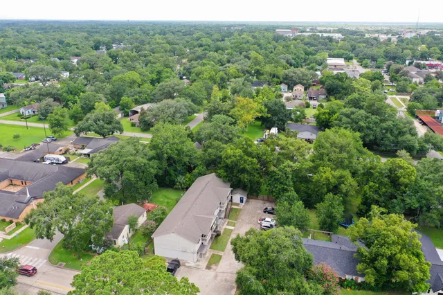 an aerial view of a houses with a yard and lake view