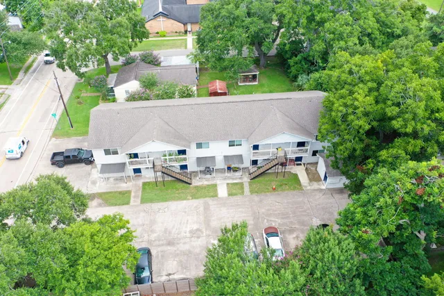 an aerial view of a house with swimming pool and patio