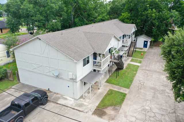 an aerial view of a house with outdoor space