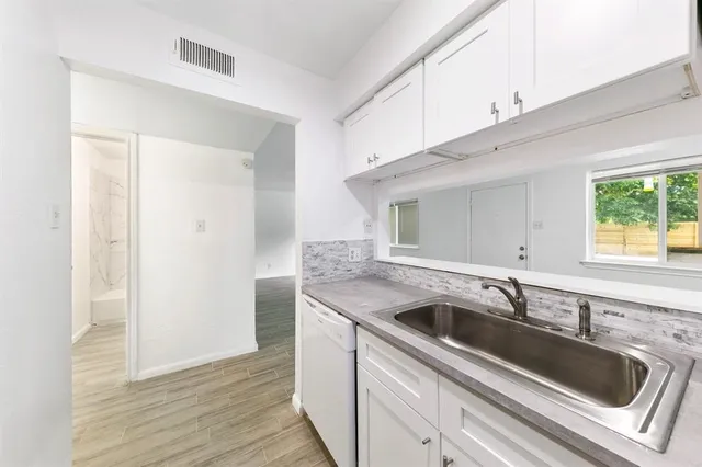 a view white cabinets and sink